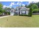 Beautiful home with a well-kept lawn and two-car garage provides excellent curb appeal at 214 Crestmont Way, Canton, GA 30114