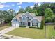Two-story home with an attached two-car garage sits on a lush green lawn at 214 Crestmont Way, Canton, GA 30114