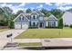 Inviting two-story home features a well-maintained lawn and attached two-car garage at 214 Crestmont Way, Canton, GA 30114