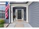 Inviting home entrance with American flag, wreath, and welcoming decor at 214 Crestmont Way, Canton, GA 30114