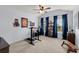 Sunlit home office features a ceiling fan, large window views, and a spacious layout perfect for productivity at 214 Crestmont Way, Canton, GA 30114