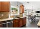 Eat-in kitchen with stainless appliances, wood cabinets, granite countertops, and an adjacent dining nook at 214 Crestmont Way, Canton, GA 30114