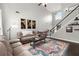 Cozy living room with a high ceiling, staircase, and comfortable seating at 214 Crestmont Way, Canton, GA 30114