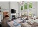 Living room featuring a fireplace, large windows, and comfortable seating at 214 Crestmont Way, Canton, GA 30114