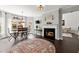 Cozy living room with a fireplace, breakfast nook, and dark hardwood floors throughout at 214 Crestmont Way, Canton, GA 30114