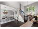 Open-concept living area featuring a staircase and large windows that bring in natural light at 214 Crestmont Way, Canton, GA 30114