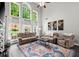 Living room boasting a high ceiling, large windows, and comfortable seating arrangement at 214 Crestmont Way, Canton, GA 30114