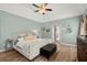 Inviting main bedroom with a ceiling fan, light-colored walls, and plush bedding at 214 Crestmont Way, Canton, GA 30114