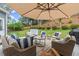 Inviting outdoor patio with comfortable seating, shaded by an umbrella, creating an ideal relaxation area at 214 Crestmont Way, Canton, GA 30114