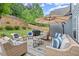 Outdoor patio featuring cozy seating, a grill, and a serene backyard view, great for entertaining guests at 214 Crestmont Way, Canton, GA 30114