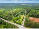 An aerial view highlights the 10.08+/- acre lot, showcasing its wooded surroundings and outlined property lines at 4380 Highway 138, Oxford, GA 30054