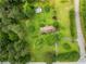 An aerial view of the property showcasing the house, green lawn, trees, and surrounding landscape at 4380 Highway 138, Oxford, GA 30054
