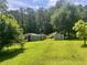 Spacious backyard features two storage sheds and is surrounded by mature trees at 4380 Highway 138, Oxford, GA 30054