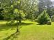 The lush backyard with mature trees is perfect for relaxing or entertaining at 4380 Highway 138, Oxford, GA 30054