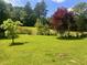 Expansive backyard surrounded by mature trees is ideal for outdoor enjoyment at 4380 Highway 138, Oxford, GA 30054