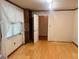 Bedroom with wood floors and trim, walk-in closet and large window with blinds at 4380 Highway 138, Oxford, GA 30054