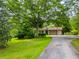 Charming single-story home with a well-maintained lawn, mature trees, and a paved driveway at 4380 Highway 138, Oxford, GA 30054