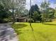 Ranch-style home with a long driveway and a spacious, well-manicured front yard at 4380 Highway 138, Oxford, GA 30054
