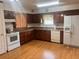The kitchen features wood cabinets, laminate flooring, and white appliances at 4380 Highway 138, Oxford, GA 30054