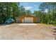 Barn with white door and truck parked on gravel area surrounded by trees at 1016 Green Dr, Canton, GA 30114