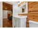 Bathroom featuring a vanity sink, toilet, and unique light fixtures and wood paneling at 1016 Green Dr, Canton, GA 30114