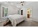 Bedroom with vaulted ceiling, ceiling fan, gray carpet, two windows, and ensuite bathroom at 1016 Green Dr, Canton, GA 30114