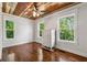 Bedroom featuring hardwood floors and dresser with multiple windows and natural light at 1016 Green Dr, Canton, GA 30114