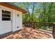 Exterior door opening onto stained wood deck with railing and outdoor light fixture at 1016 Green Dr, Canton, GA 30114