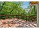 Large stained wooden deck surrounded by a dense forest provides a peaceful outdoor space at 1016 Green Dr, Canton, GA 30114