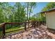 Spacious stained wooden deck with black metal railing provides view of forest and grounds at 1016 Green Dr, Canton, GA 30114