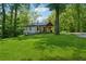 Exterior elevation shows a home with a manicured lawn, mature trees and a covered porch at 1016 Green Dr, Canton, GA 30114