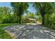 Home's exterior with trees, long driveway, and lush landscaping at 1016 Green Dr, Canton, GA 30114