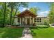 Charming home with inviting front porch, stone path, mature trees, and lush lawn at 1016 Green Dr, Canton, GA 30114