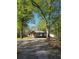 Charming single-story home with a gable roof, and lots of trees in a peaceful wooded setting at 1016 Green Dr, Canton, GA 30114