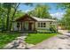 Charming home with inviting front porch, stone path, mature trees, and lush lawn at 1016 Green Dr, Canton, GA 30114
