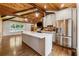 Kitchen area boasting wood ceilings, exposed beams, and a large island with stainless steel appliances at 1016 Green Dr, Canton, GA 30114