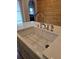 Close up of white farmhouse style kitchen sink with stainless steel faucet and spray nozzle at 1016 Green Dr, Canton, GA 30114