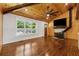 Spacious living room features wood floors, vaulted ceiling with fan, wood-burning stove, and large windows at 1016 Green Dr, Canton, GA 30114
