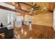 Living space featuring wood floors, vaulted ceiling, wood burning stove, and view into kitchen and bathroom at 1016 Green Dr, Canton, GA 30114