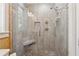 Modern shower with gray tile, pebble floor, built-in seat, and multiple shower heads at 1016 Green Dr, Canton, GA 30114
