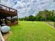 Large backyard with a fenced perimeter, a wooded boundary, and access to an upper deck and lower porch at 19 Magnolia Ne Ct, Rydal, GA 30171