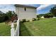 Exterior view of the back of the house with a fenced yard, landscaping, and deck at 19 Magnolia Ne Ct, Rydal, GA 30171