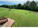 Sprawling backyard showing the verdant grass, and the deck of the home at 19 Magnolia Ne Ct, Rydal, GA 30171