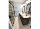 Bathroom featuring double sinks with wood cabinets and a glass door shower at 19 Magnolia Ne Ct, Rydal, GA 30171