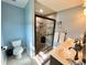Modern bathroom with a double vanity, glass shower, and decorative stone flooring at 19 Magnolia Ne Ct, Rydal, GA 30171
