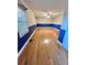 Modern bedroom featuring hardwood floors, two windows, and blue accents at 19 Magnolia Ne Ct, Rydal, GA 30171
