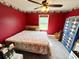 Bedroom with red walls, neutral carpet, a window for natural light and closet for storage at 19 Magnolia Ne Ct, Rydal, GA 30171