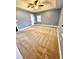 Carpeted bedroom featuring a tray ceiling, ceiling fan, and natural light at 19 Magnolia Ne Ct, Rydal, GA 30171