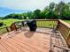 This is a deck with a grill on it that looks out over the lush green yard at 19 Magnolia Ne Ct, Rydal, GA 30171