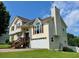 Two-story house featuring a two-car garage, a chimney and a staircase leading up to the front door at 19 Magnolia Ne Ct, Rydal, GA 30171